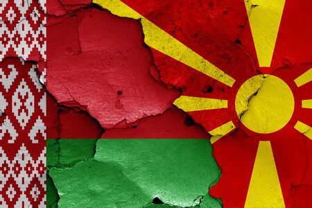 flags of Belarus and North Macedonia painted on cracked wallの写真素材