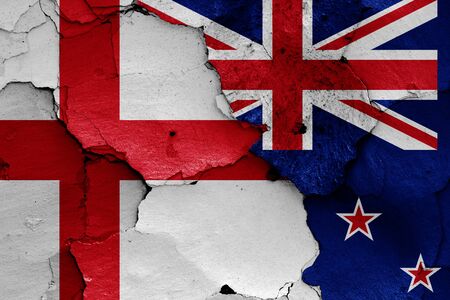 flags of England and New Zealand painted on cracked wallの写真素材