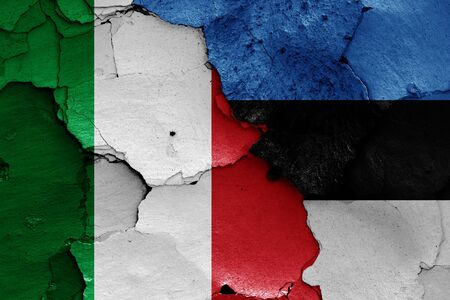 flags of Italy and Estonia painted on cracked wallの写真素材