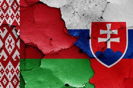 flags of Belarus and Slovakia painted on cracked wallの写真素材
