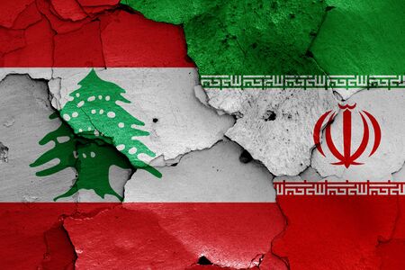 flags of Lebanon and Iran painted on cracked wallの写真素材