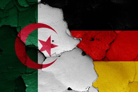 flags of Algeria and Germany painted on cracked wallの写真素材