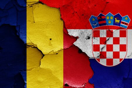 flags of Romania and Croatia painted on cracked wallの写真素材