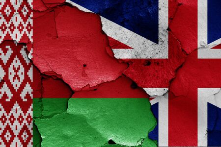 flags of Belarus and UK painted on cracked wallの写真素材