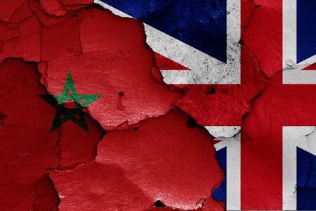 flags of Morocco and UK painted on cracked wallの写真素材