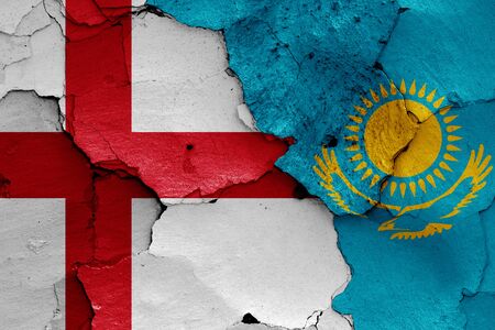 flags of England and Kazakhstan painted on cracked wallの写真素材