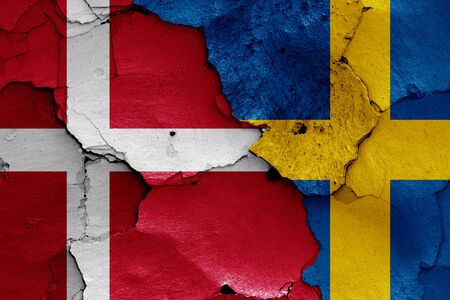 flags of Denmark and Sweden painted on cracked wallの写真素材
