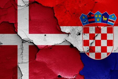 flags of Denmark and Croatia painted on cracked wallの写真素材