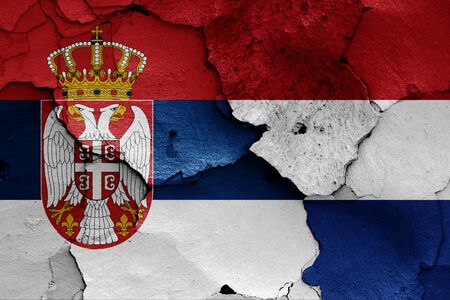 flags of Serbia and Nettherlands painted on cracked wallの写真素材