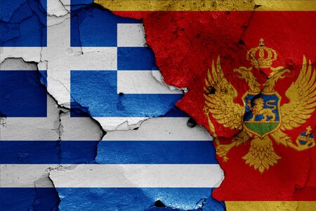 flags of Greece and Montenegro painted on cracked wallの写真素材