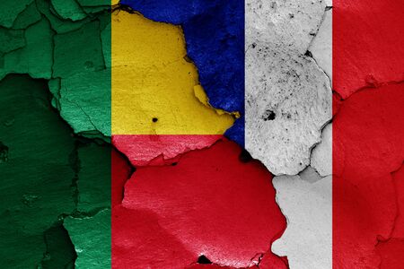flags of Benin and France painted on cracked wallの写真素材