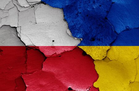 flags of Poland and Ukraine painted on cracked wallの写真素材