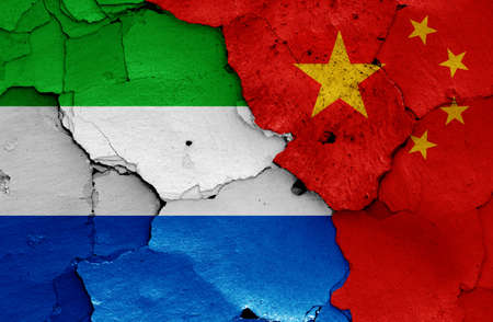 flags of Sierra Leone and China painted on cracked wallの写真素材