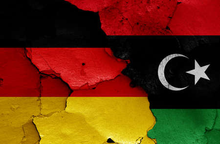 flags of Germany and Libya painted on cracked wallの写真素材