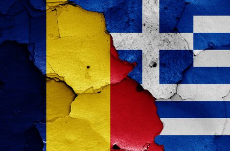 flags of Romania and Greece painted on cracked wallの写真素材