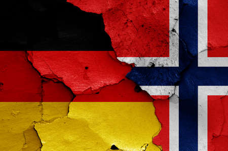 flags of Germany and Norway painted on cracked wallの写真素材