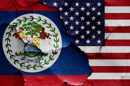 flags of Belize and USA painted on cracked wallの写真素材