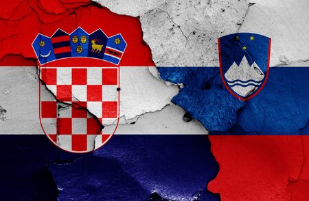 flags of Croatia and Slovenia painted on cracked wallの写真素材