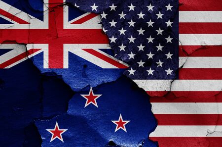 flags of New Zealand and USA painted on cracked wallの写真素材