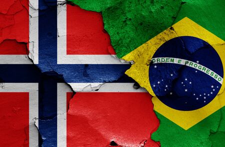 flags of Norway and Brazil painted on cracked wallの写真素材