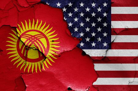 flags of Kyrgyzstan and USA painted on cracked wallの写真素材