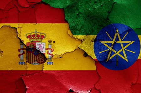 flags of Spain and Ethiopia painted on cracked wallの写真素材