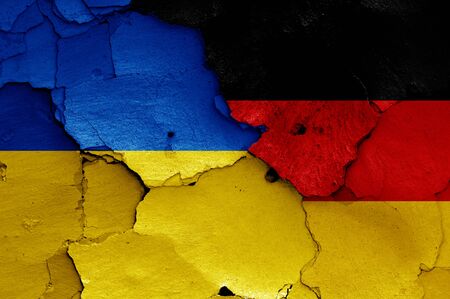 flags of Ukraine and Germany painted on cracked wallの写真素材