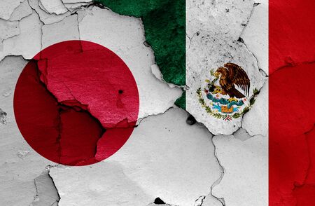 flags of Japan and Mexico painted on cracked wallの写真素材