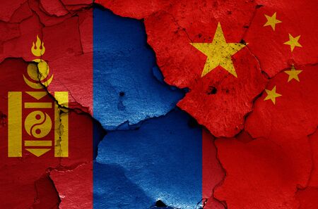 flags of Mongolia and China painted on cracked wallの写真素材