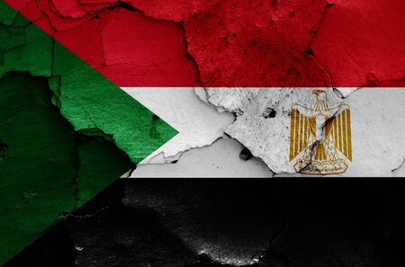 flags of Sudan and Egypt painted on cracked wallの写真素材