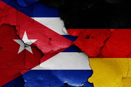 flags of Cuba and Germany painted on cracked wallの写真素材