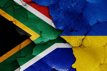 flags of South Africa and Ukraine painted on cracked wallの写真素材