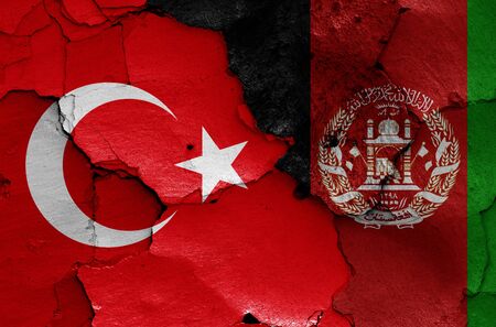 flags of Turkey and Afghanistan painted on cracked wallの写真素材