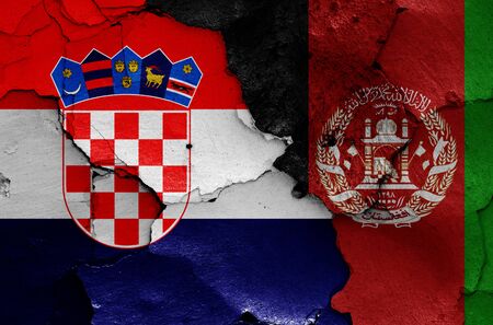 flags of Croatia and Afghanistan painted on cracked wallの写真素材