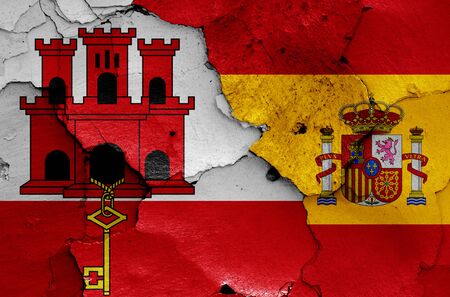 flags of Gibraltar and Spain painted on cracked wallの写真素材