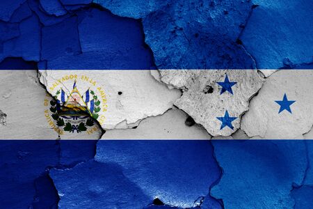flags of El Salvador and Honduras painted on cracked wallの写真素材