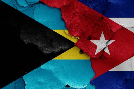 flags of Bahamas and Cuba painted on cracked wallの写真素材