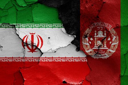 flags of Iran and Afghanistan painted on cracked wallの写真素材
