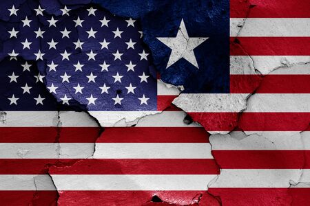 flags of USA and Liberia painted on cracked wallの写真素材