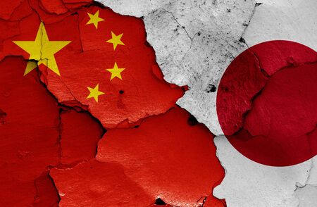flags of China and Japan painted on cracked wallの写真素材