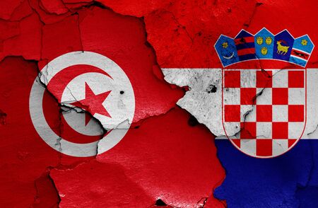 flags of Tunisia and Croatia painted on cracked wallの写真素材