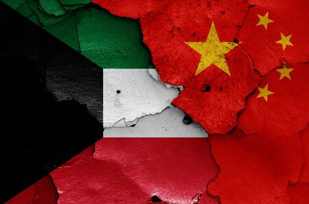 flags of Kuwait and China painted on cracked wallの写真素材