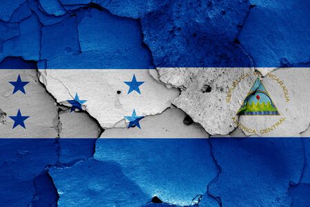 flags of Honduras and Nicaragua painted on cracked wallの写真素材