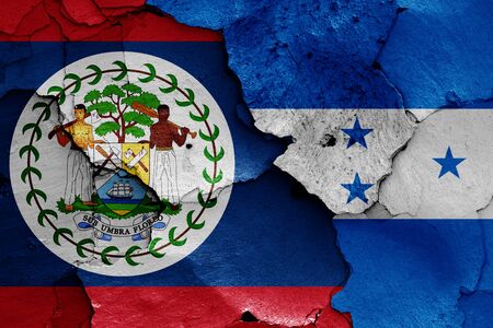 flags of Belize and Honduras painted on cracked wallの写真素材