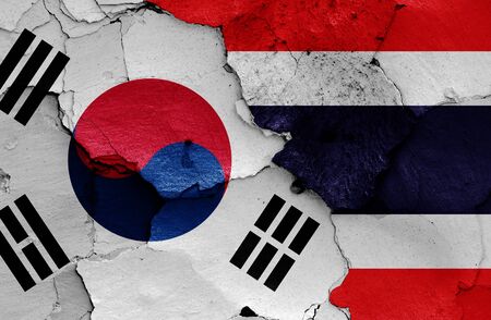 flags of South Korea and Thailand painted on cracked wallの写真素材