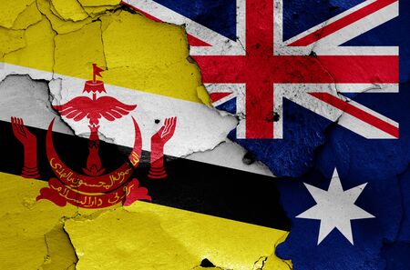 flags of Brunei and Australia painted on cracked wallの写真素材
