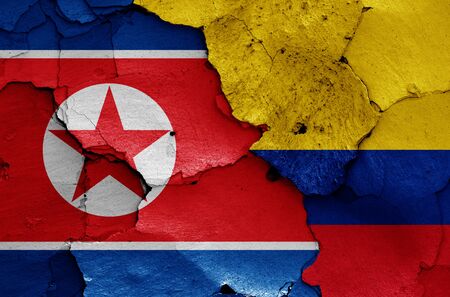 flags of North Korea and Colombia painted on cracked wallの写真素材