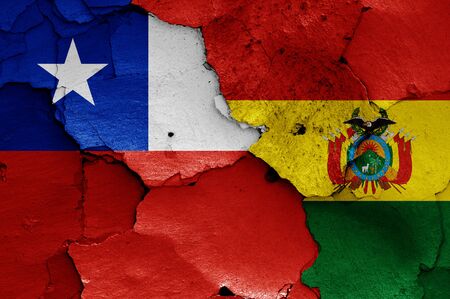 flags of Chile and Bolivia painted on cracked wallの写真素材