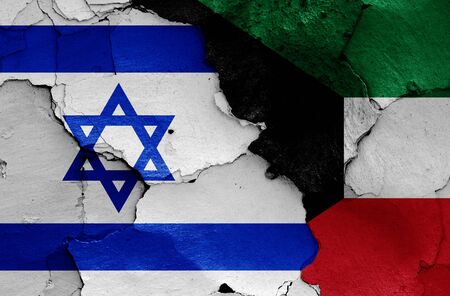 flags of Israel and Kuwait painted on cracked wallの写真素材