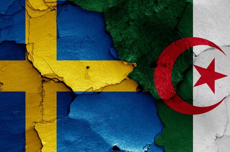 flags of Sweden and Algeria painted on cracked wallの写真素材